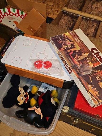 Three vintage Mickey mouse characters, board game Clue, miniature air hockey game untested,  poker chips and cards, and Jenga.