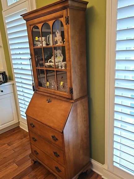 Wood secretary with two doors and 3 drawers. Keys work locks properly. 26.5 x 15.5x 71.5 in tall. Content's not included.