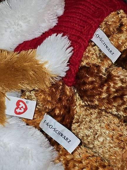 Two FAO Schwartz bears and a TY Beanie Buddy dog.