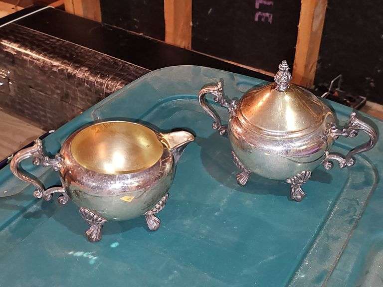 Tub of silver plate items. Two teapots, heated coffee pot, covered sugar, and creamer.