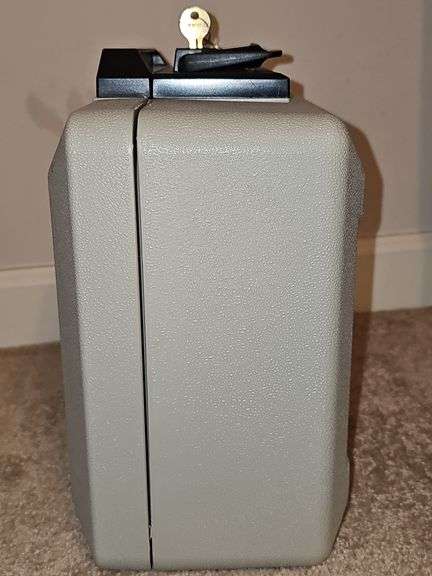 Sentry 1100 safe with key. Exterior dimensions 14 X 10.5 x 6.5 in tall.