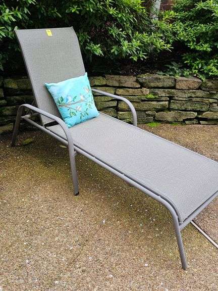 Adjustable patio lounge chair with cushion.