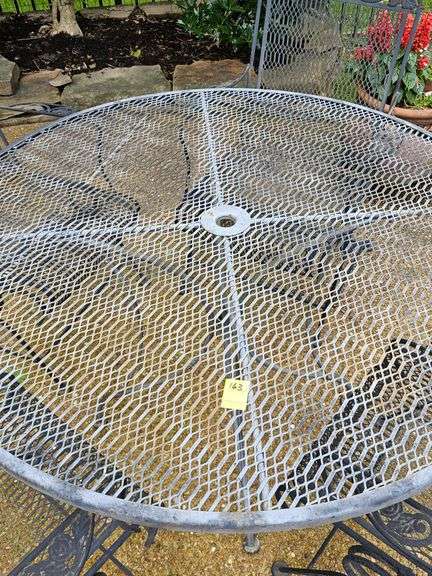 Iron patio table and four spring rocking chairs.