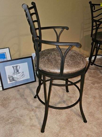 Metal bar stool with padded seat.