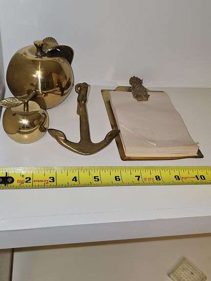 Grouping of brass items. Large apple, small apple, anchor, pineapple note holder.