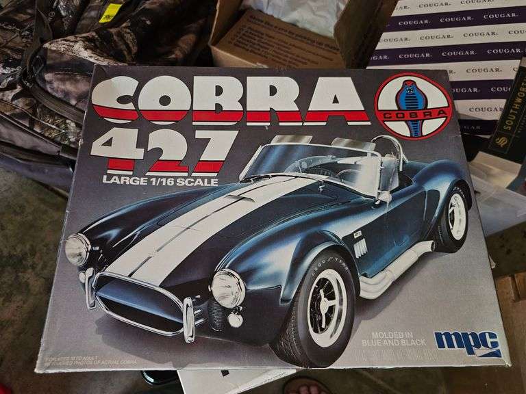 Unopened model airplane, model car, paint brushes and paints