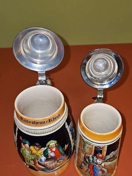 2 steins. One is 7.25 in from West Germany,  8.25 in is from Germany