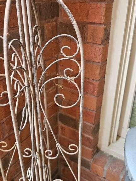 Metal folding trestle with bird finial. 45 in tall