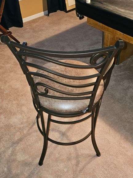Metal bar stool with padded seat.
