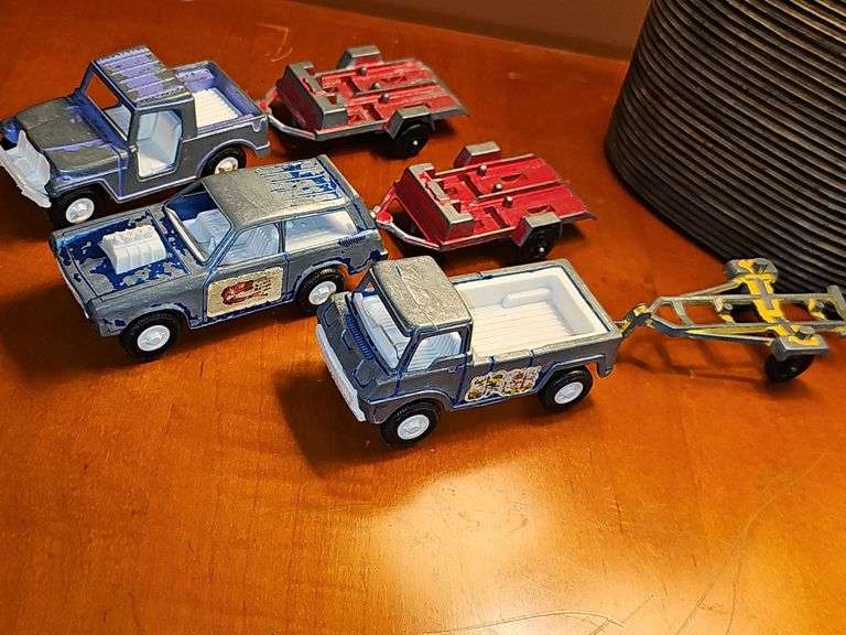 Diecast vehicles. All have been played with. The train in the front is Midge Toy, most of the rest are Tootsie Toy.