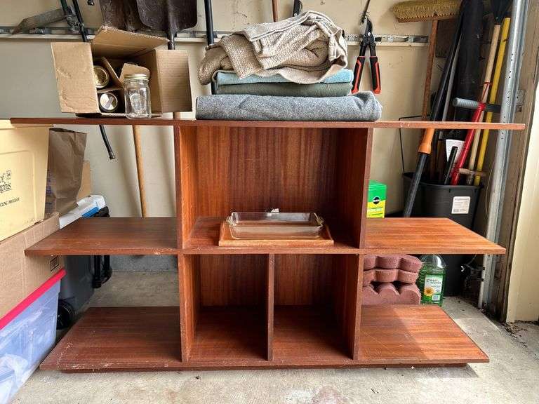 Multi-tiered bookshelf and contents sitting on shelf…..60-1/4 x 16 x 34-1/2…..does have scratching…..BACKGROUND CONTENTS NOT INCLUDED