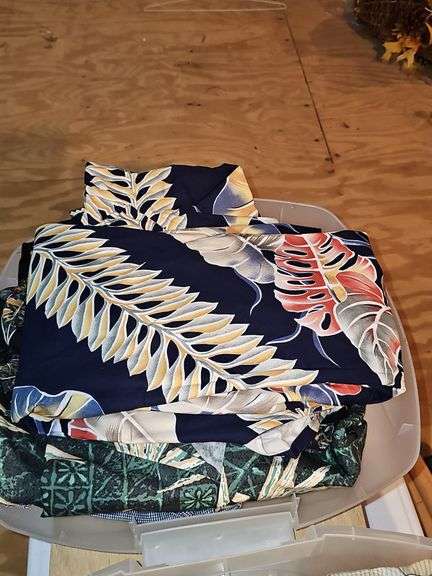 Small container of Hawaiian leis and shirts.