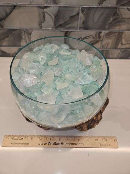 Beautiful molten glass bowl filled with sand and aqua blue crushed rock sitting on teak driftwood...