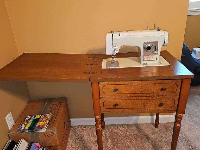 Vintage Sears Kenmore sewing machine in cabinet with storage chair. Closed cabinet is 22.5x18 X 30 in tall. Chair is 16 X 13 X 27.5 in tall. Seat height is 17 in
