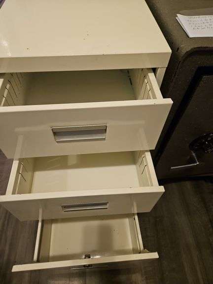 Three-drawer metal file cabinet...