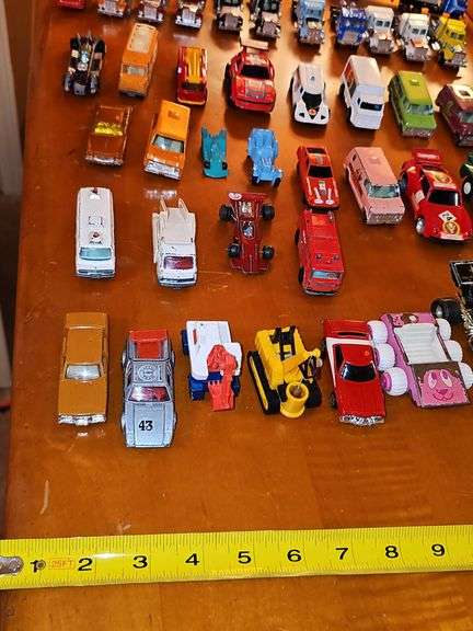 Grouping of diecast tractor-trailer toys and others from various makers.