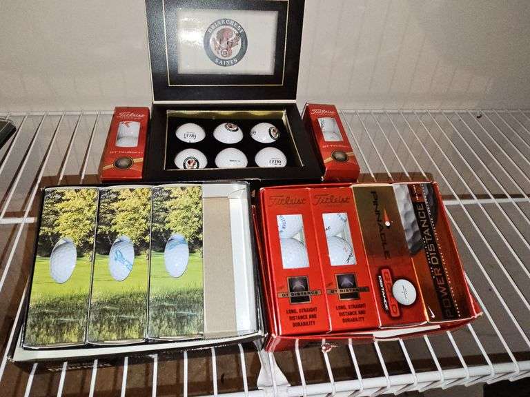 Grouping of golf balls. All boxes are full. Spalding, Titleist, and briarcrest saints.