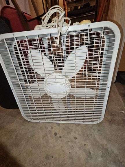 Square card table and box fan.