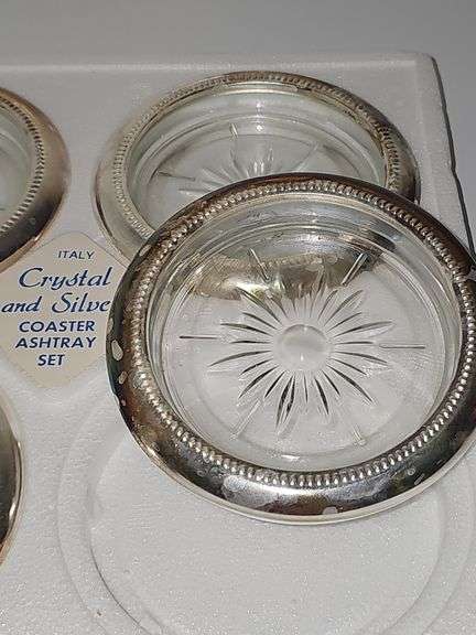 Three boxes of silver plate rimmed coasters or ashtrays. One box has not been opened.
