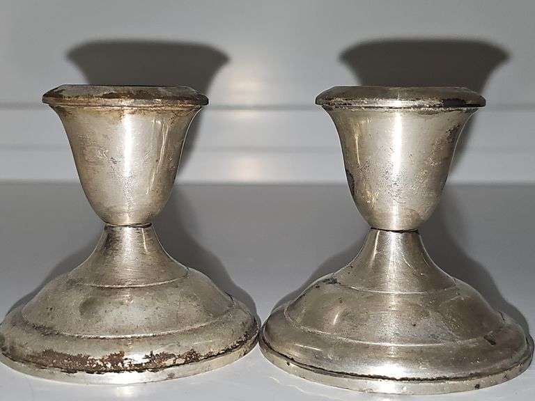 Pair of sterling weighted candlesticks. 2.75 in tall.