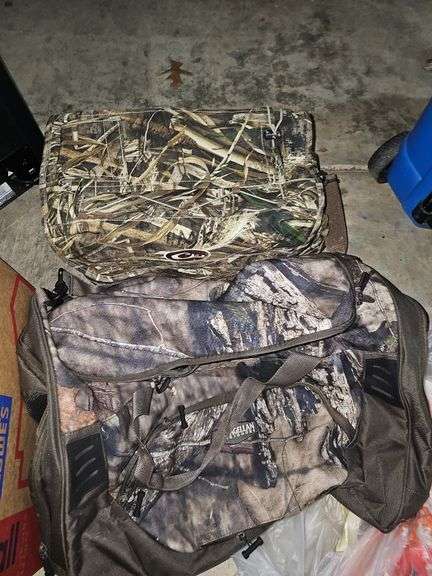 Two camo duffel bags. The smaller one has winter gloves in it.