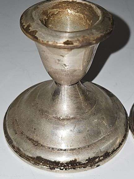 Pair of sterling weighted candlesticks. 2.75 in tall.