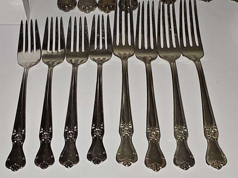 Old company plate flatware possibly Signature Rose pattern. Four dinner forks, four salad forks, five soup spoons, four iced teaspoons, four dinner knives, two serving spoons, one ladle, one cold meat fork, one sugar spoon, and one butter knife. No monogram.  Circa 1940s