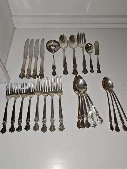 Old company plate flatware possibly Signature Rose pattern. Four dinner forks, four salad forks, five soup spoons, four iced teaspoons, four dinner knives, two serving spoons, one ladle, one cold meat fork, one sugar spoon, and one butter knife. No monogram.  Circa 1940s