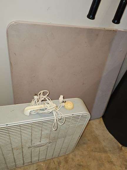 Square card table and box fan.