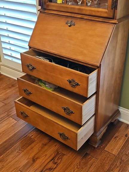 Wood secretary with two doors and 3 drawers. Keys work locks properly. 26.5 x 15.5x 71.5 in tall. Content's not included.