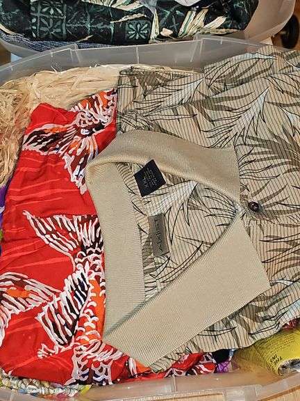 Small container of Hawaiian leis and shirts.