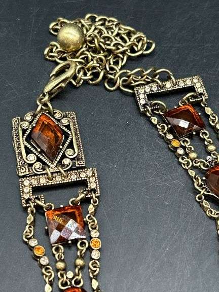 Nice looking gold tone with amber colored stones ladies belt…..adjustable for waist size