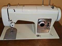 Vintage Sears Kenmore sewing machine in cabinet with storage chair. Closed cabinet is 22.5x18 X 30 in tall. Chair is 16 X 13 X 27.5 in tall. Seat height is 17 in
