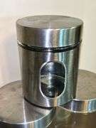 Set of (3) glass and stainless storage jars and (1) all stainless…..heights range from 9” down to 5”