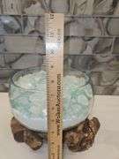 Beautiful molten glass bowl filled with sand and aqua blue crushed rock sitting on teak driftwood...