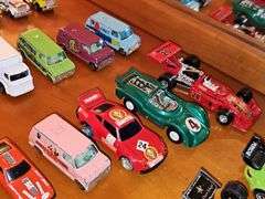 Grouping of diecast tractor-trailer toys and others from various makers.