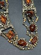 Nice looking gold tone with amber colored stones ladies belt…..adjustable for waist size