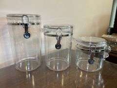 Set of (4) OGGI acrylic canisters…..only 1 has spoon….heights range from 4” to 9” tall…..another was found after initial listing