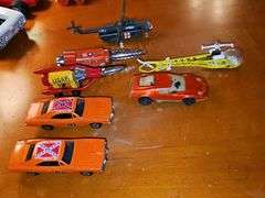 Toy vehicle grouping. Larger vehicles in the back are plastic, planes and General Lee cars or metal diecast.