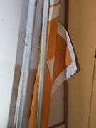 Three flag poles. One has a UT  flag. Silver poles are 72 in. UT is 48 in.