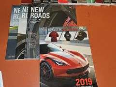 Grouping of Corvette dealership brochures, America sports car magazines, and new roads magazines.