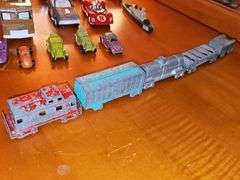 Diecast vehicles. All have been played with. The train in the front is Midge Toy, most of the rest are Tootsie Toy.