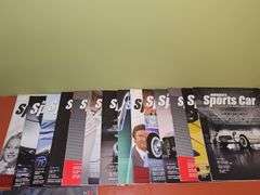 Grouping of Corvette dealership brochures, America sports car magazines, and new roads magazines.