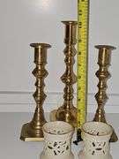 Three brass candlesticks and two Lenox tea lights