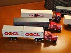 Grouping of diecast tractor-trailer toys and others from various makers.