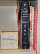 Grouping of children's books and a Bible verse.