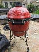 Red Kamado Joe Grill on rollaround iron stand w/cover and some like new accessories...
