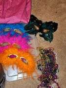 Miscellaneous grouping. Super Grover t-shirt,pink apron, Mardi gras style masks, beads, polar bear hat, and more.