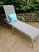 Adjustable patio lounge chair with cushion.