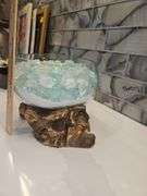 Beautiful molten glass bowl filled with sand and aqua blue crushed rock sitting on teak driftwood...